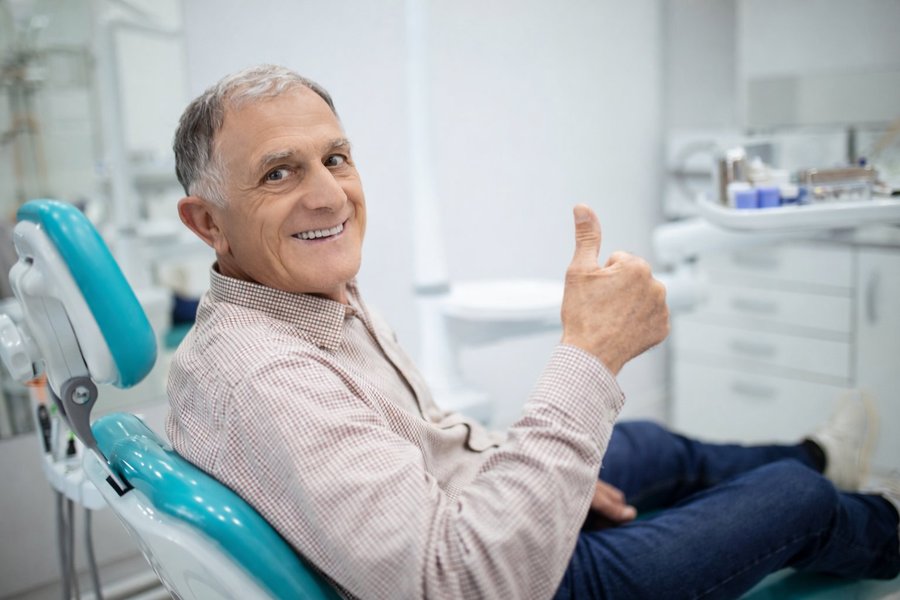 Happy patient after dentures at POSH Smiles Ashburn VA