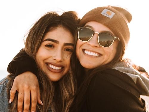 young women smiling and hugging | dentist ashburn va