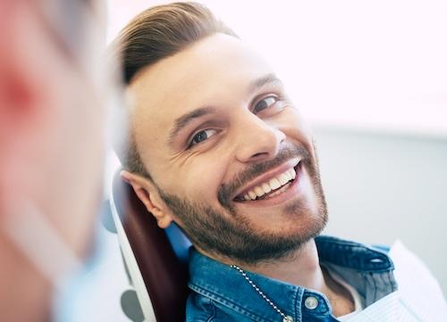 Man smiling at dentist in dental chair, ashburn va