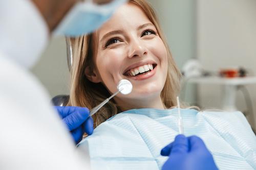 Woman with red hair smiling in dental chair, ashburn va