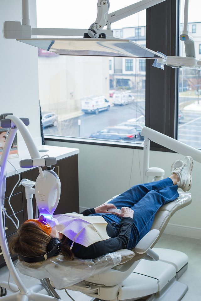 Patient receiving professional in-office teeth whitening treatment at POSH Smiles in Ashburn, VA